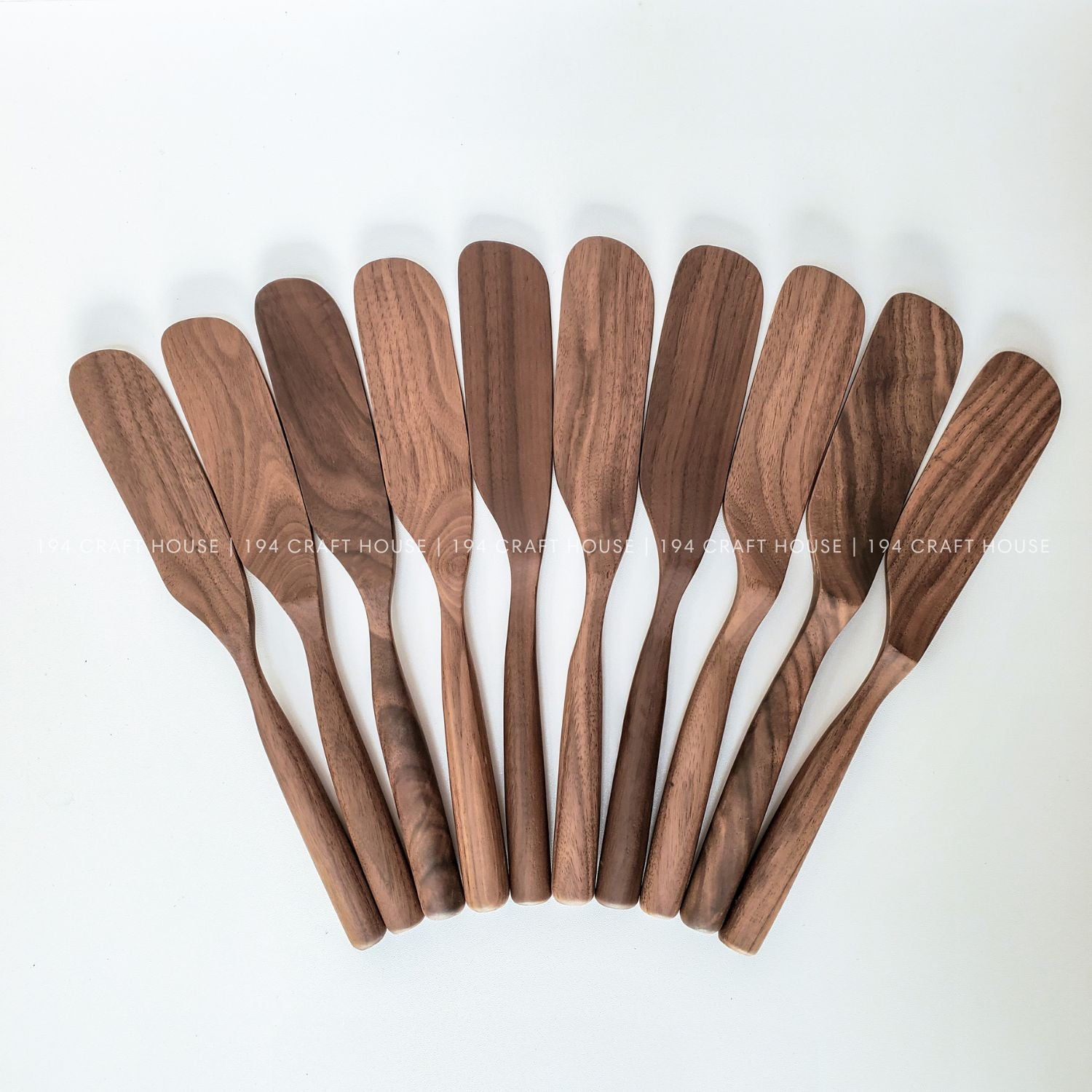 Set of handcrafted walnut wooden spreader knives with natural wood grain variations