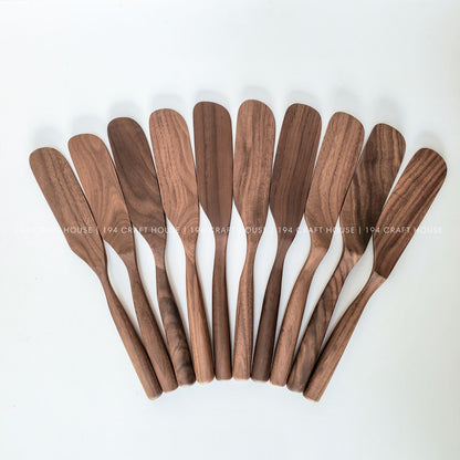 Set of handcrafted walnut wooden spreader knives with natural wood grain variations