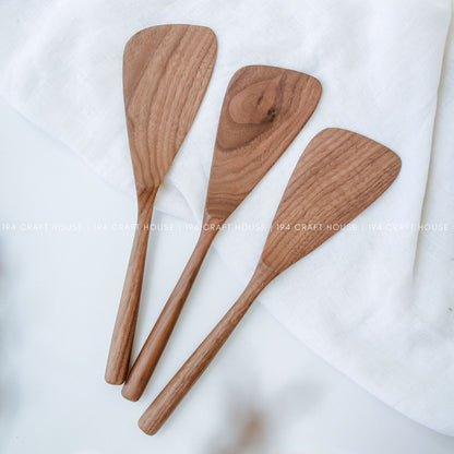 Three handcrafted walnut wooden spatulas for stirring, mixing, and serving