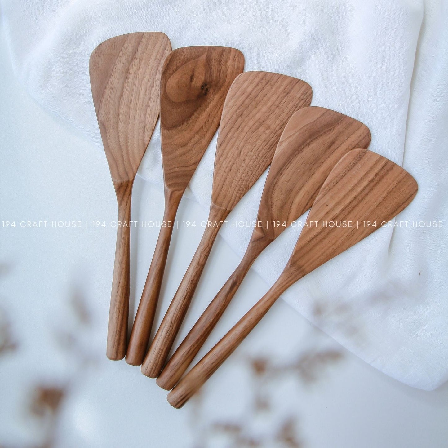 Collection of walnut wood spatulas showing natural color and grain variations