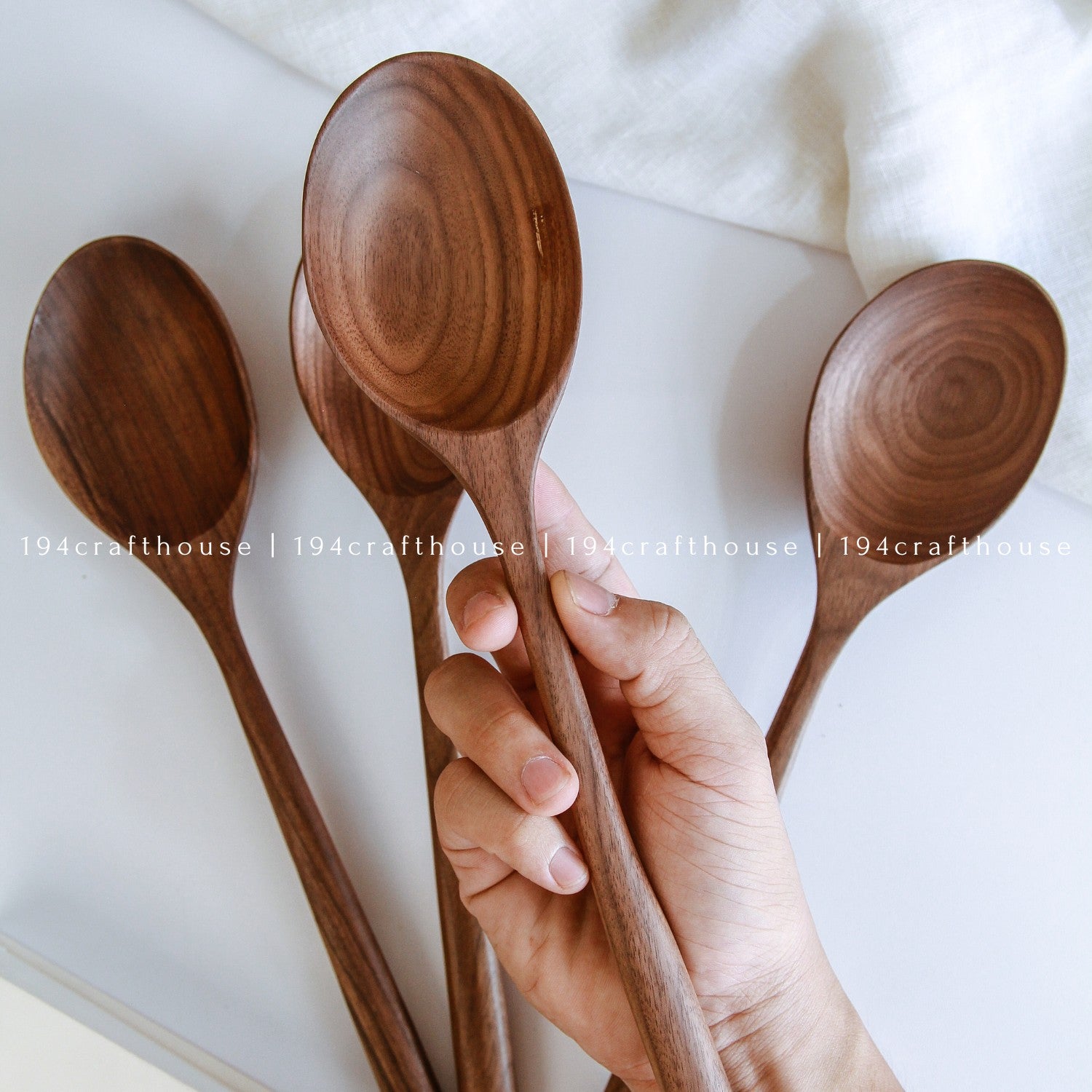 Handcrafted walnut wooden serving spoon with a broad spoon head and long handle