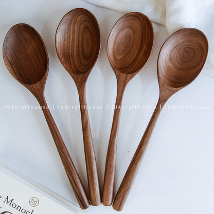 Four handcrafted large walnut wooden serving spoons with unique natural grain