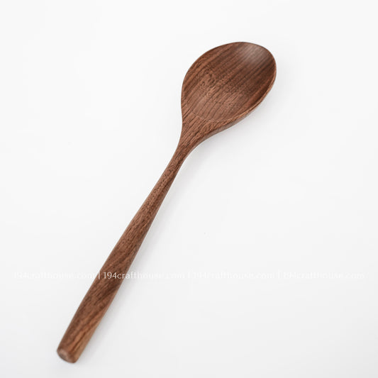 Handmade walnut wooden spoon with natural wood grain, eco-friendly kitchen utensil