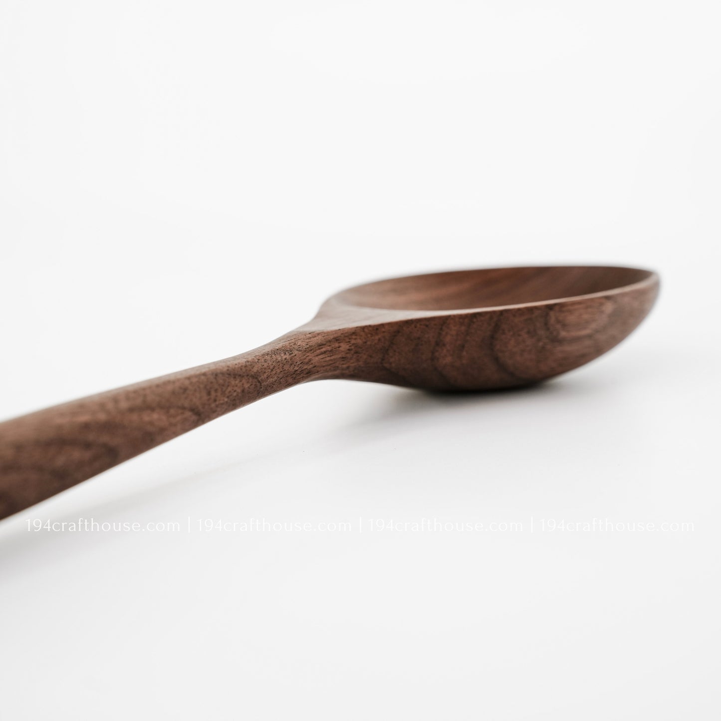 Handmade walnut wooden spoon with natural wood grain, eco-friendly kitchen utensil