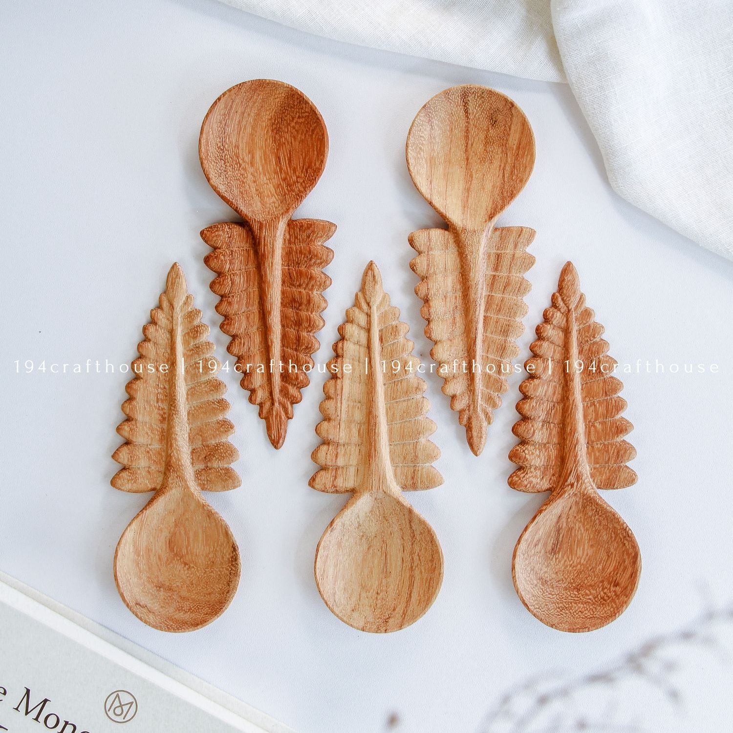 Set of five hand-carved Doussie wood fern leaf spoons on a clean white background, handcrafted cottagecore kitchen utensils and decor by 194 Craft House.