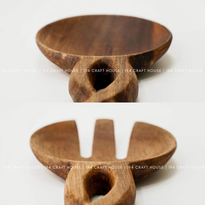 Close-up of handcrafted wooden salad spoon and fork with carved chain-link handles