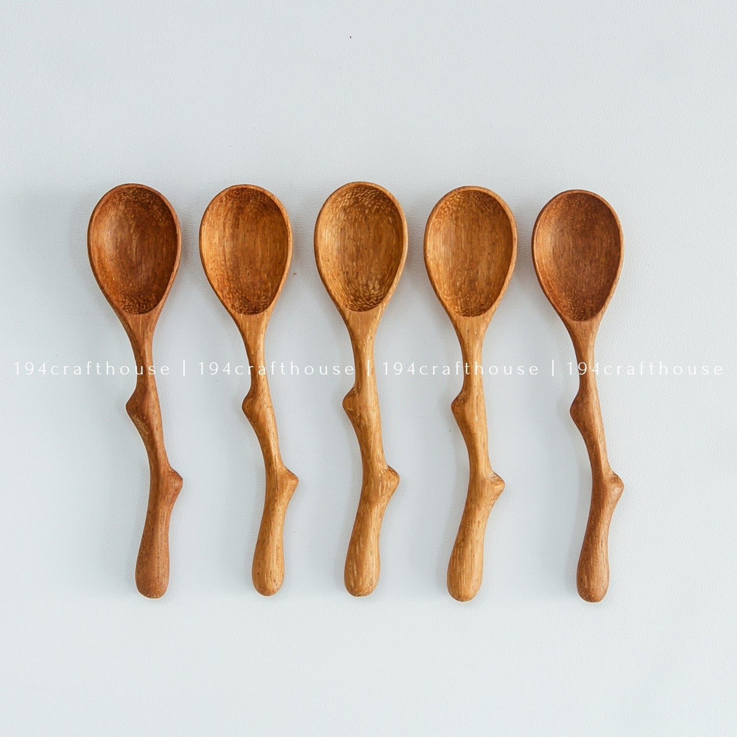 Collection of small wooden spice scoops with natural wood grain