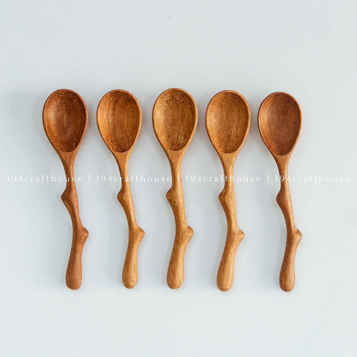 Collection of small wooden spice scoops with natural wood grain