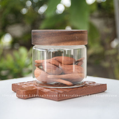 Mini wooden spoons displayed with glass jars for spices, sugar, salt, tea, and coffee
