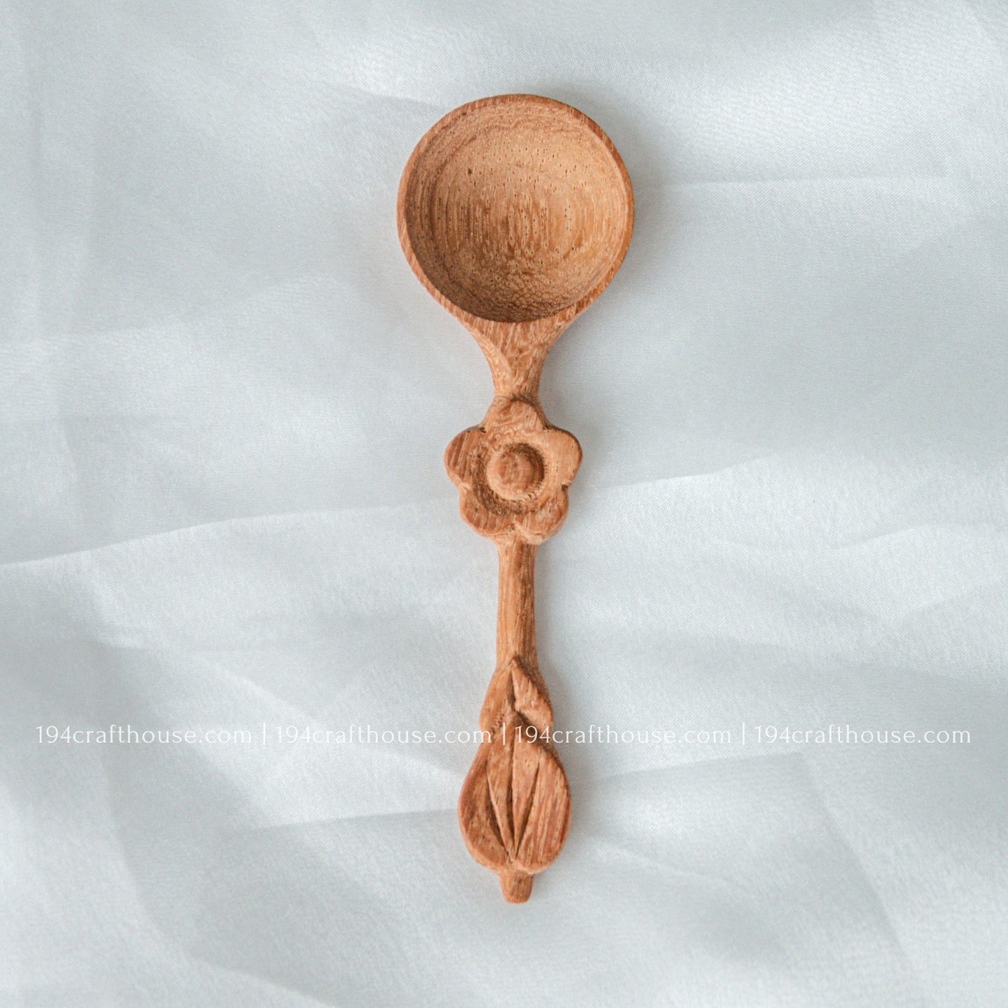 Handcrafted wooden spice spoon with a decorative flower-shaped handle and smooth natural finish