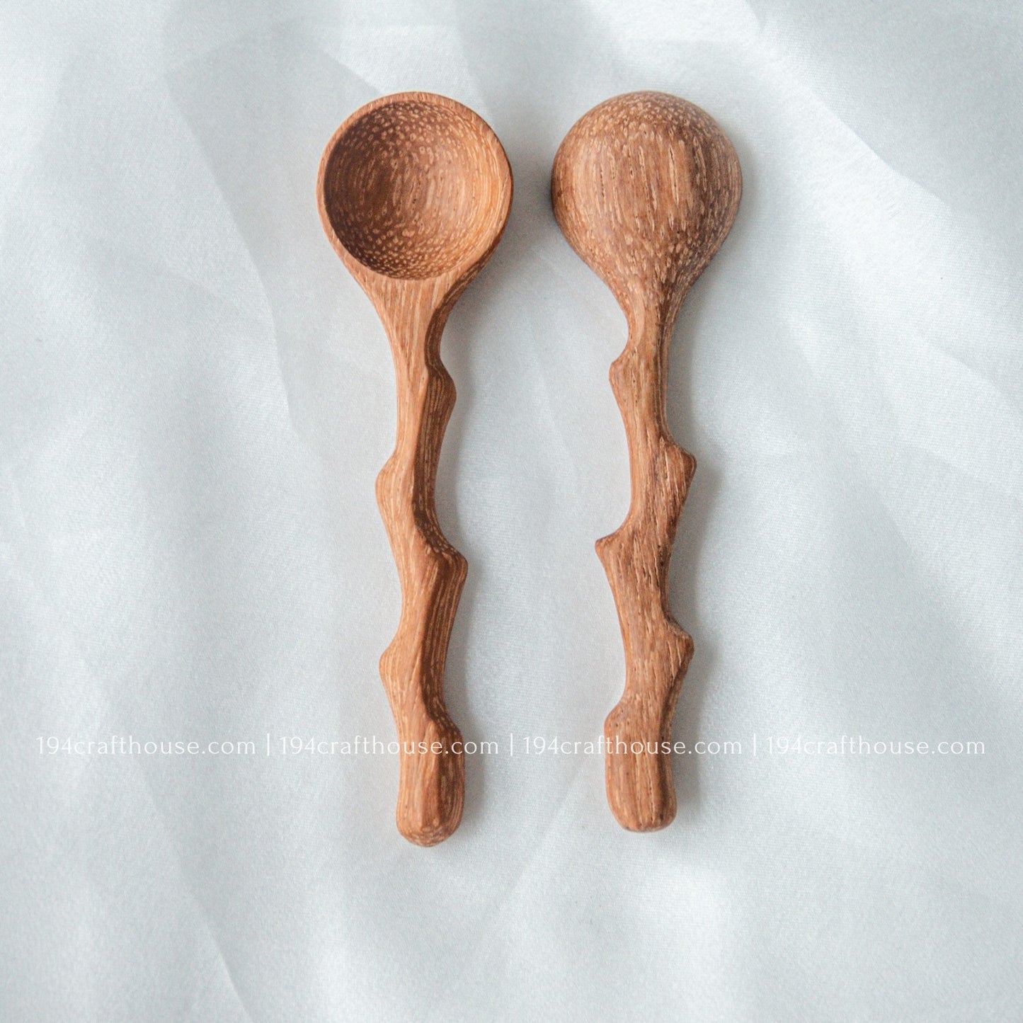 Set of three handcrafted wooden spice spoons with branch-inspired handles and natural wood grain