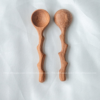 Set of three handcrafted wooden spice spoons with branch-inspired handles and natural wood grain