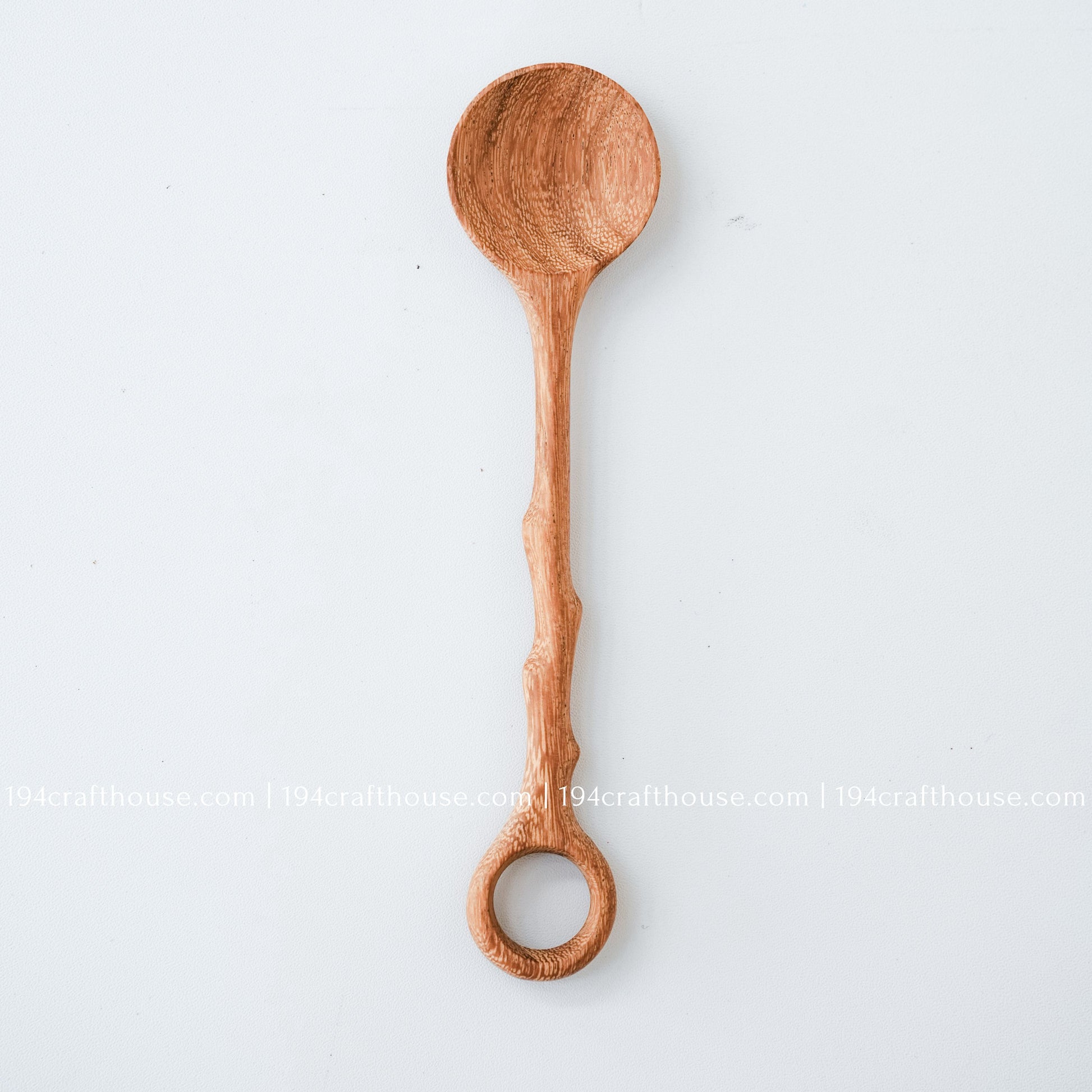 Handcrafted branch-tree wooden coffee stirring spoon with a decorative hole handle and natural wood grain