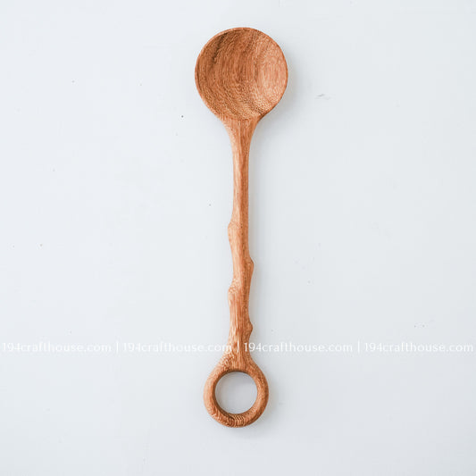 Handcrafted branch-tree wooden coffee stirring spoon with a decorative hole handle and natural wood grain