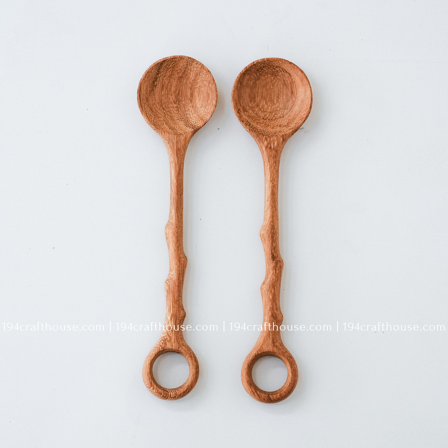 Set of two handcrafted branch-tree wooden stirring spoons with decorative hole handles
