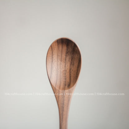 Front view of a handcrafted 6-inch walnut wooden spoon showcasing its smooth finish and rich natural walnut wood grain