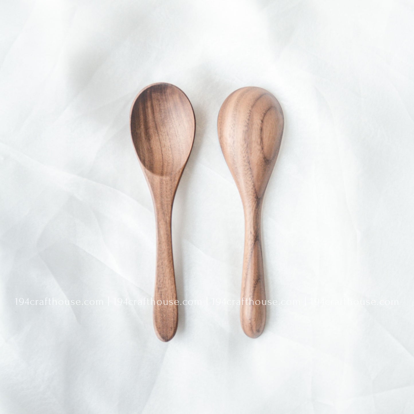 Set of two handcrafted 6-inch walnut wooden spoons displayed from the front with beautiful natural walnut wood grain