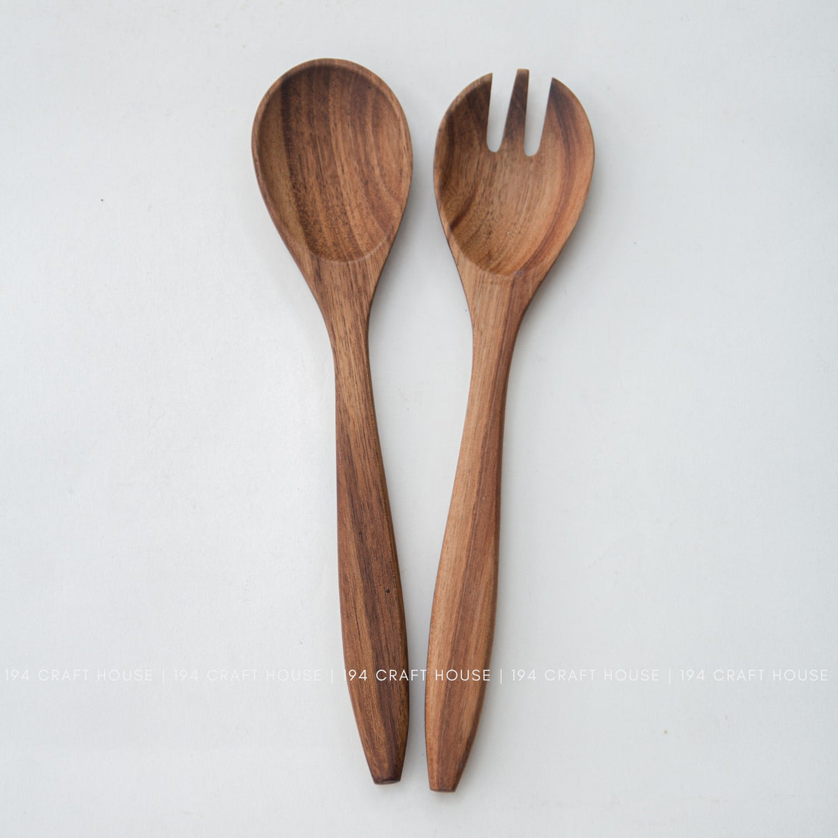 Top view of acacia wood salad spoon and fork with a rounded spoon bowl and slotted fork