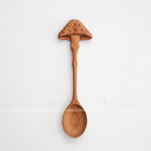 Hand-carved mushroom wooden spoon crafted from doussie wood, featuring a sculpted mushroom cap handle on a white background.