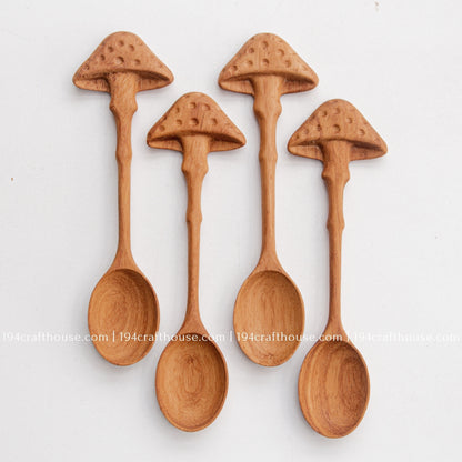 Set of 4 Hand-carved mushroom wooden spoons crafted from doussie wood, featuring a sculpted mushroom cap handle on a white background.