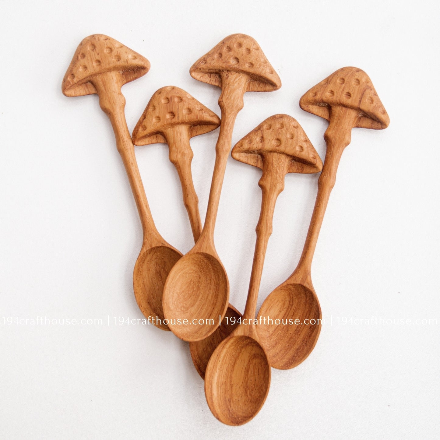 Set of 5 Hand-carved mushroom wooden spoons crafted from doussie wood, featuring a sculpted mushroom cap handle on a white background.