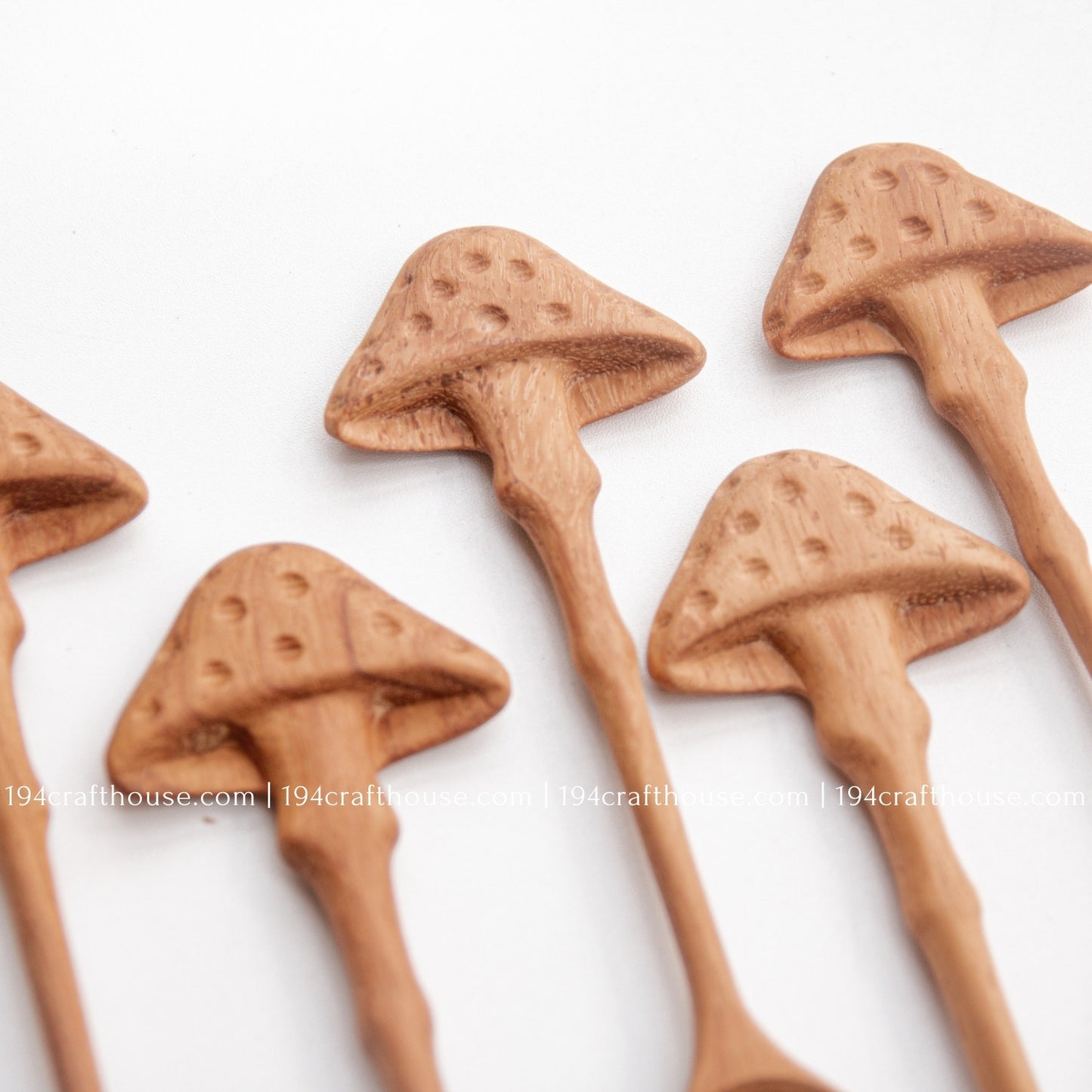 Close-up of hand-carved mushroom-shaped handles showing artisan details