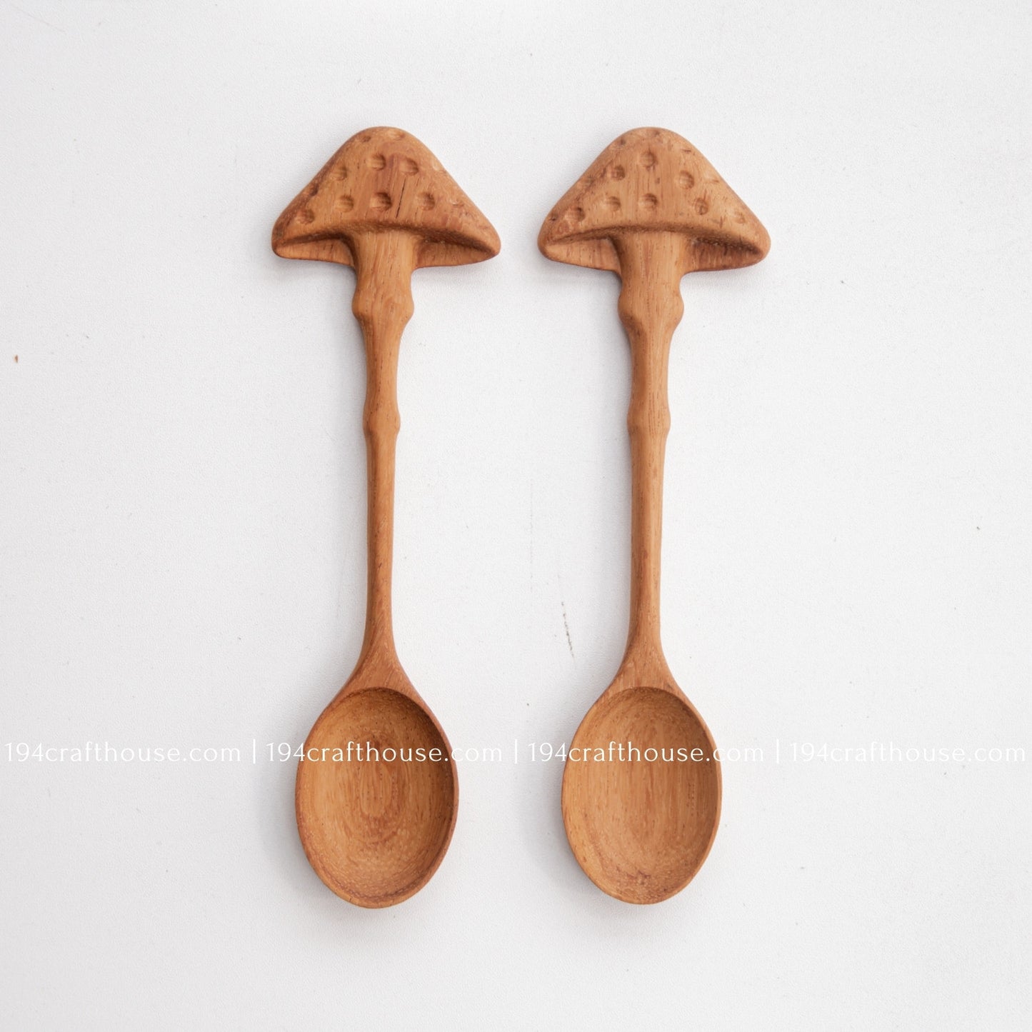 Pair of hand-carved mushroom wooden spoons with natural wood grain