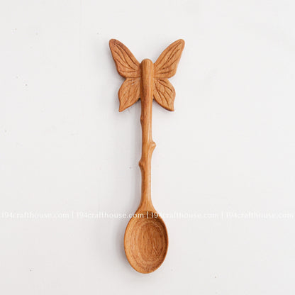 Hand-carved Butterfly wooden spoon crafted from doussie wood, featuring a sculpted butterfly handle on a white background.