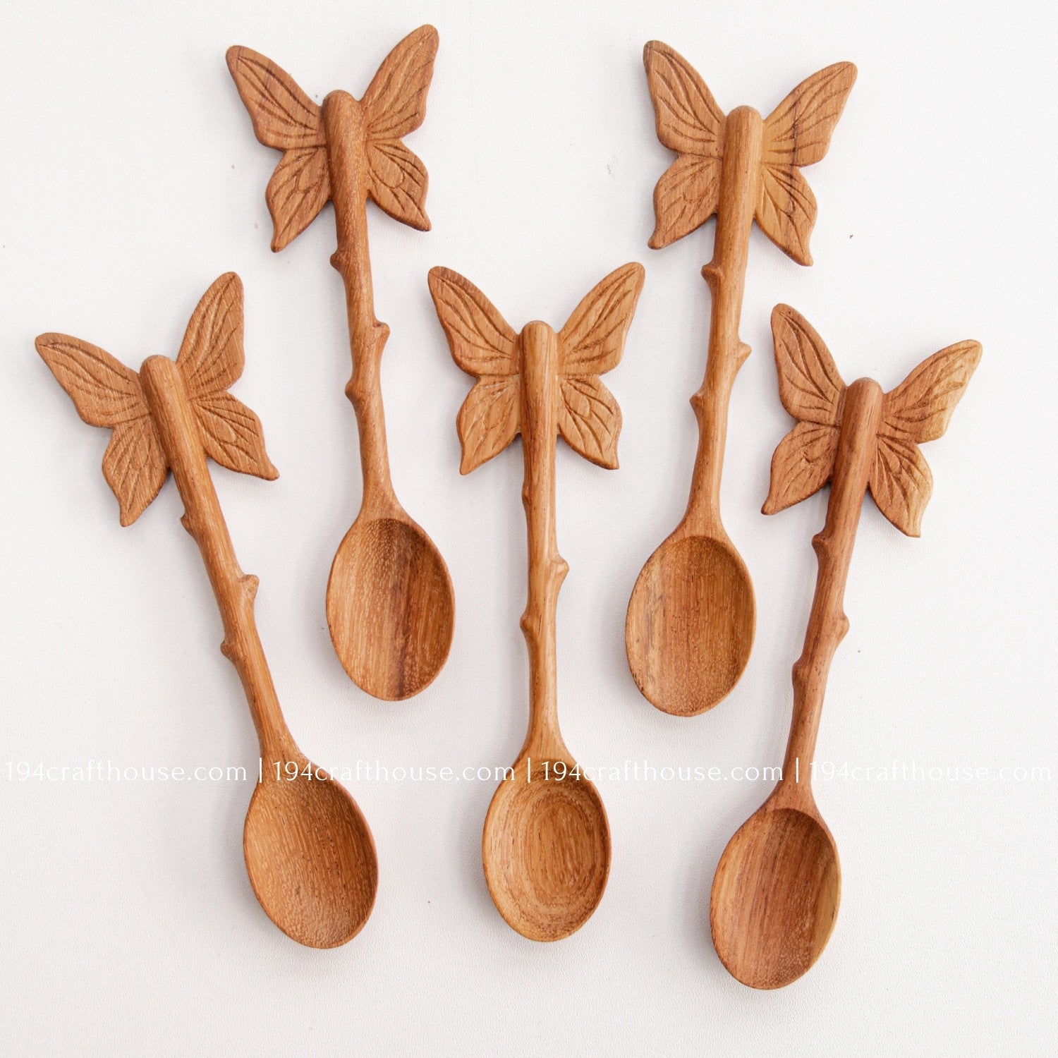 Hand-carved Butterfly wooden spoons crafted from doussie wood, featuring a sculpted butterfly handle on a white background.