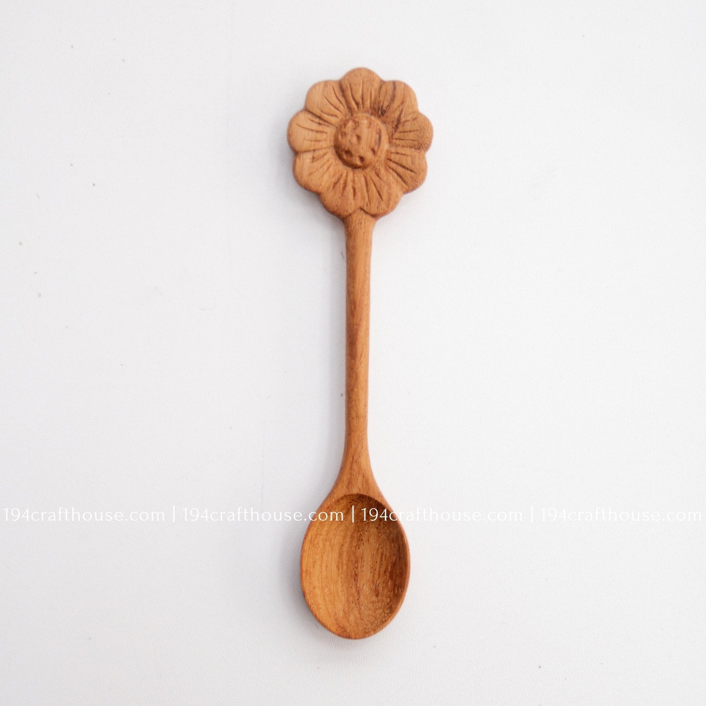 Hand-carved Flower wooden spoons crafted from doussie wood, featuring a sculpted flower handle on a white background.