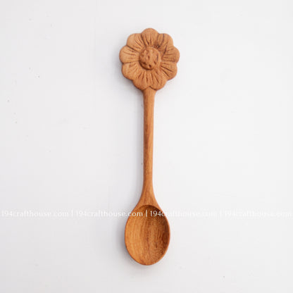 Hand-carved Flower wooden spoons crafted from doussie wood, featuring a sculpted flower handle on a white background.