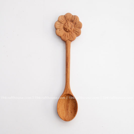 Hand-carved Flower wooden spoons crafted from doussie wood, featuring a sculpted flower handle on a white background.