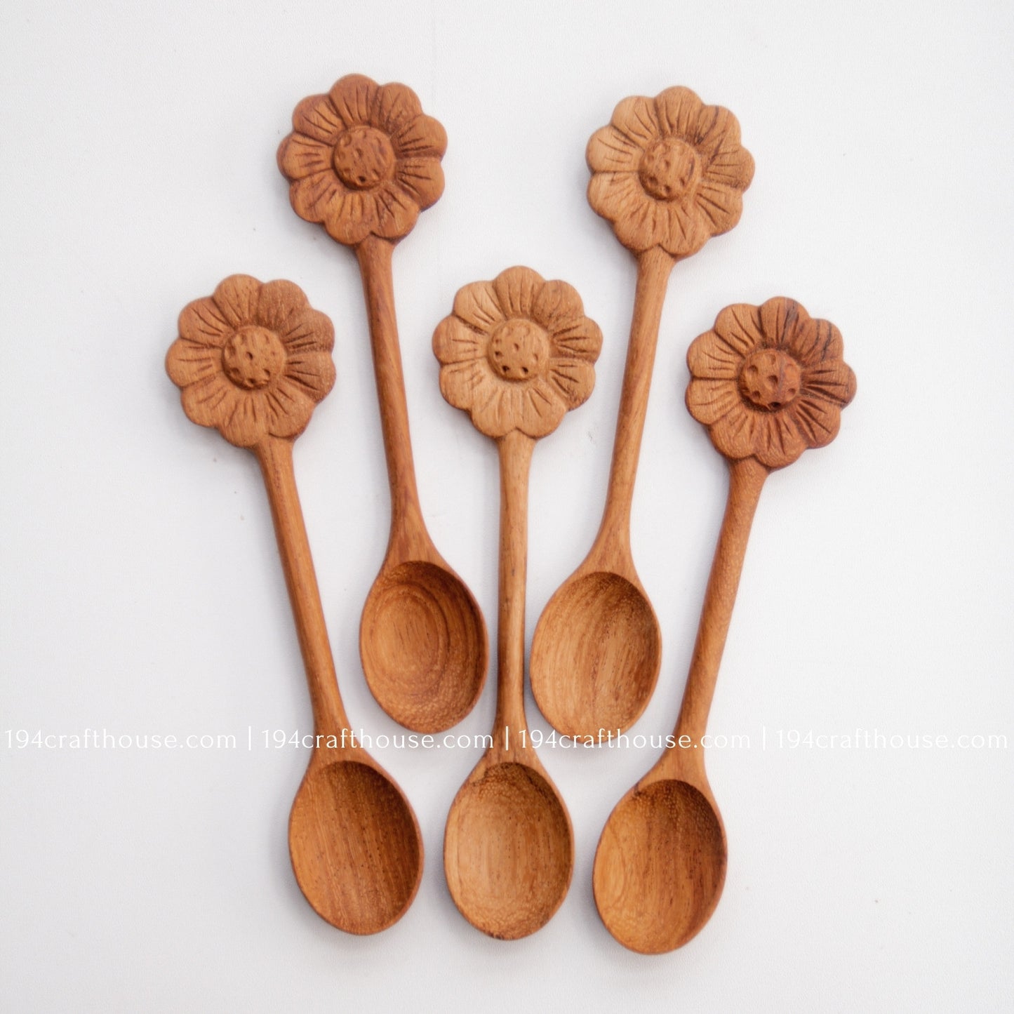 Hand-carved Flower wooden spoons crafted from doussie wood, featuring a sculpted flower handle on a white background.