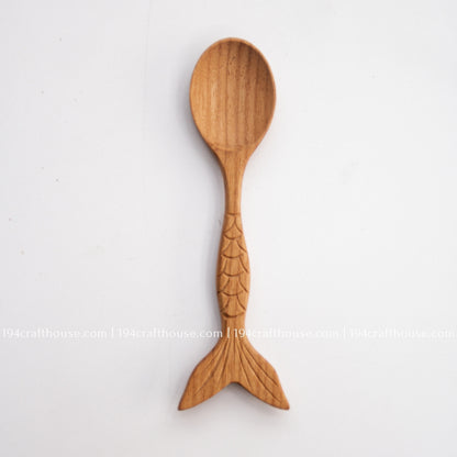 Single fish-tail handle Doussie wood spoon shown full length on a clean pale background.