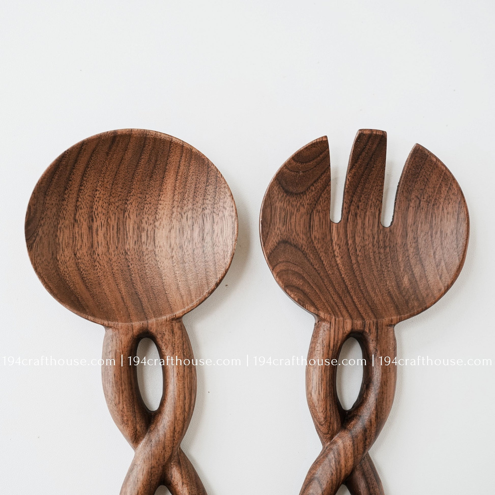 Front view of a handcrafted wooden salad spoon and fork set with decorative chain-link handles