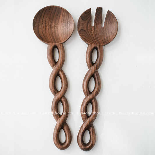 Handcrafted wooden salad server set with carved chain-link handles and rich natural wood grain