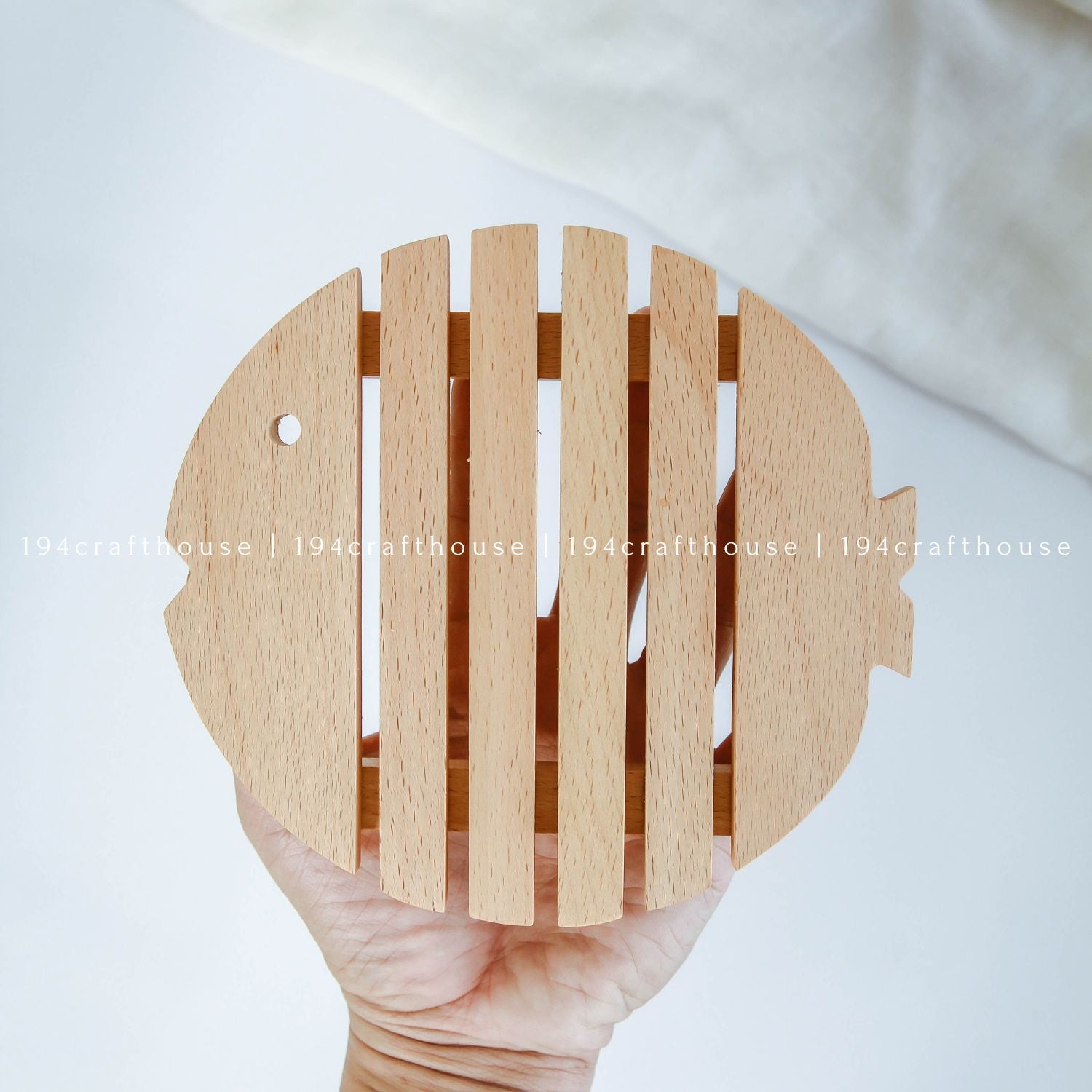 Handcrafted wooden fish-shaped trivet for protecting tables from hot pots and cookware