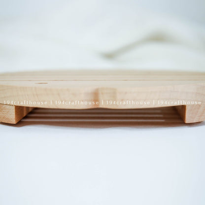 Handcrafted wooden fish trivet used as a heat-resistant pot holder on a kitchen surface