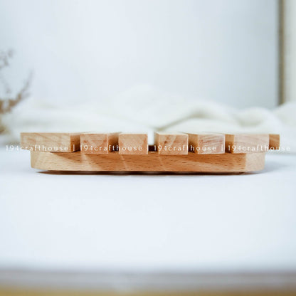 Wooden fish-shaped trivet placed under a hot pot to protect kitchen and dining surfaces