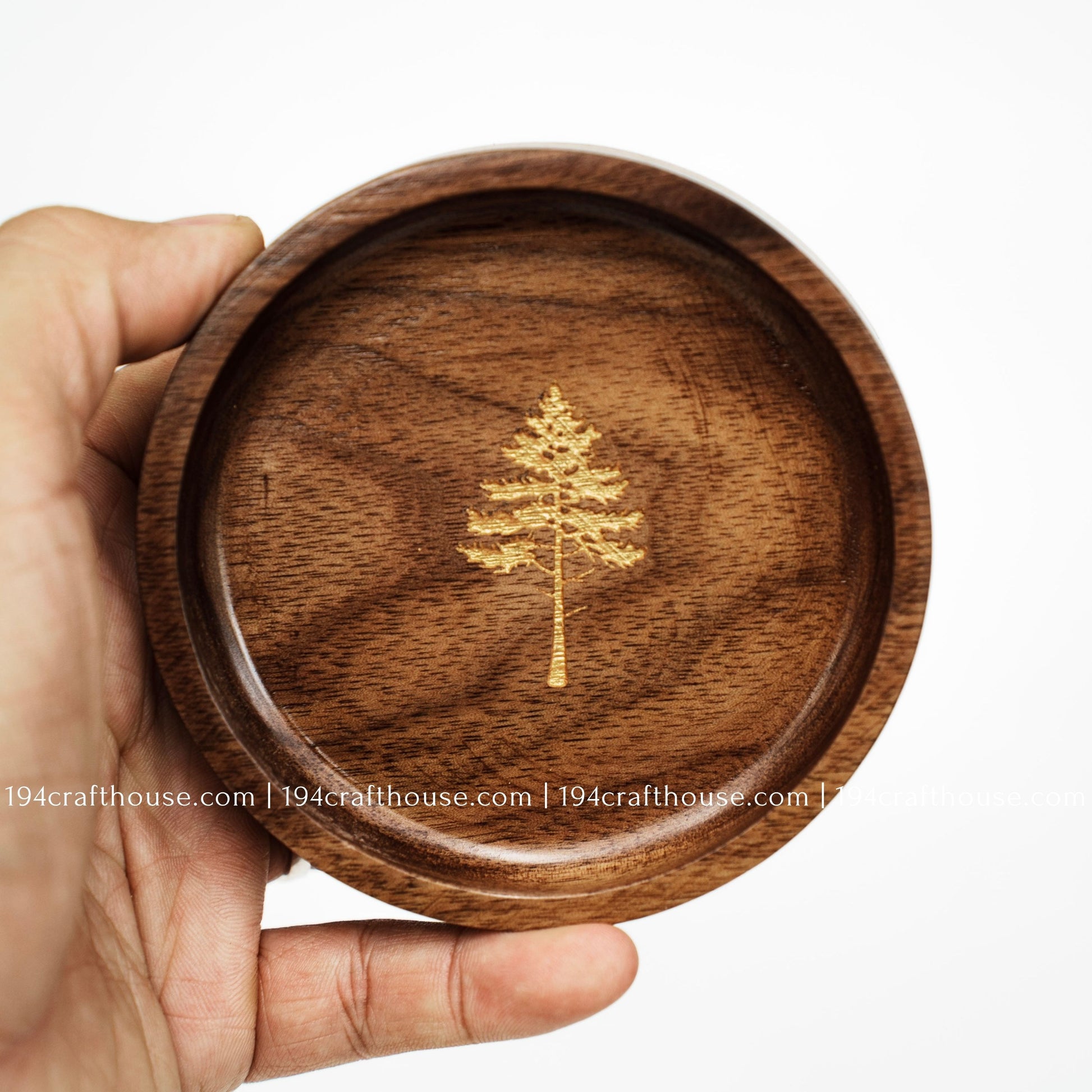 Handcrafted walnut wood jewelry tray with pine tree engraving held in hand, ideal for rings and small keepsakes