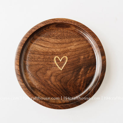 Handmade walnut wood jewelry dish with a small gold heart engraving, designed as a ring tray and keepsake dish