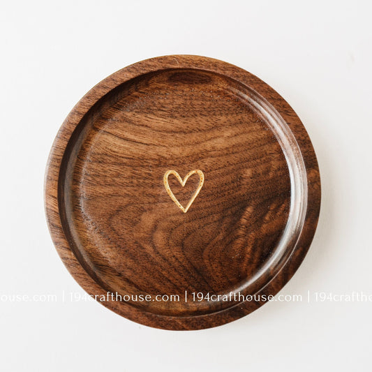 Handmade walnut wood jewelry dish with a small gold heart engraving, designed as a ring tray and keepsake dish