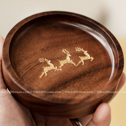 Handmade walnut wood jewelry dish showcasing rich natural grain, carved edges, and engraved deer trio detail
