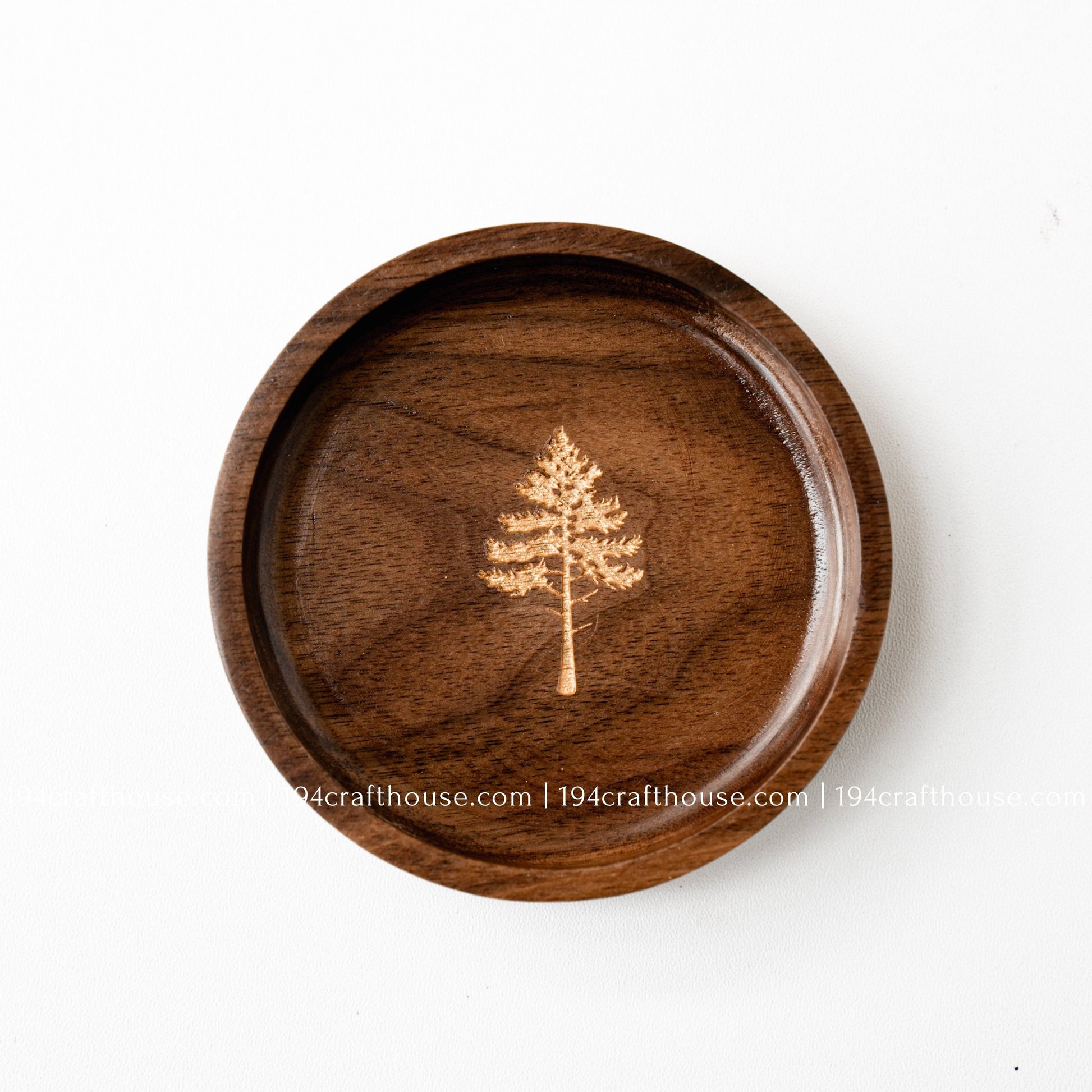 Handmade walnut wood jewelry dish with a pine tree engraving, designed as a small ring tray and keepsake dish