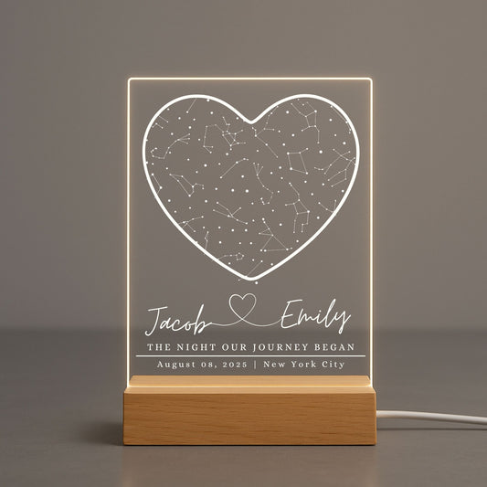 Close-up of a clear acrylic night light featuring a laser-engraved star map of a specific date and location.