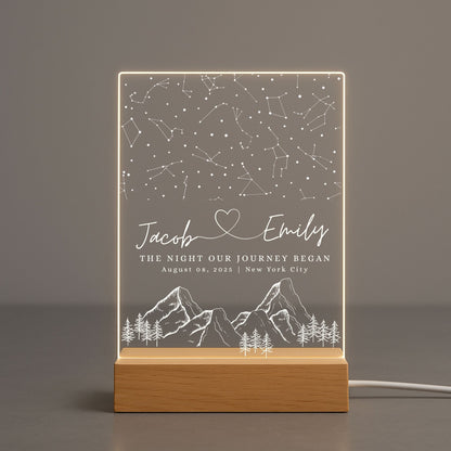 A clear acrylic night light featuring a detailed white star map of a specific date and location