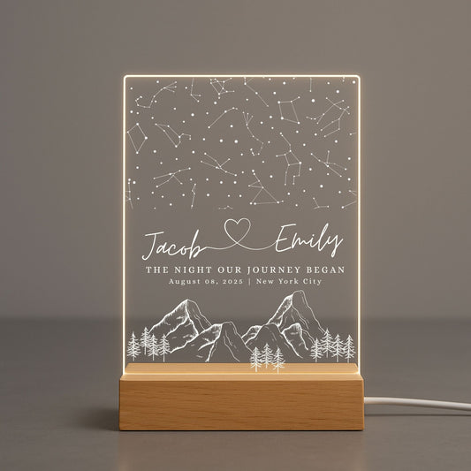 A clear acrylic night light featuring a detailed white star map of a specific date and location