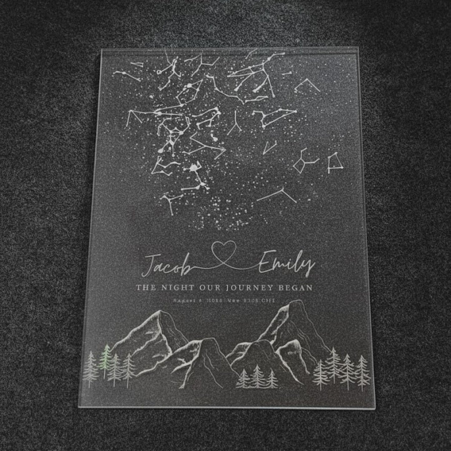 Close-up of a clear sleek acrylic plaque star map engraved