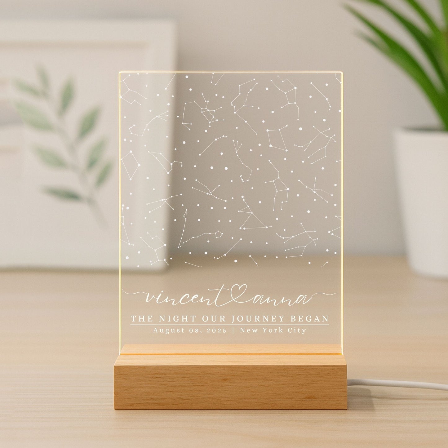 Minimalist home office desk with a glowing star map night light as a decorative centerpiece.