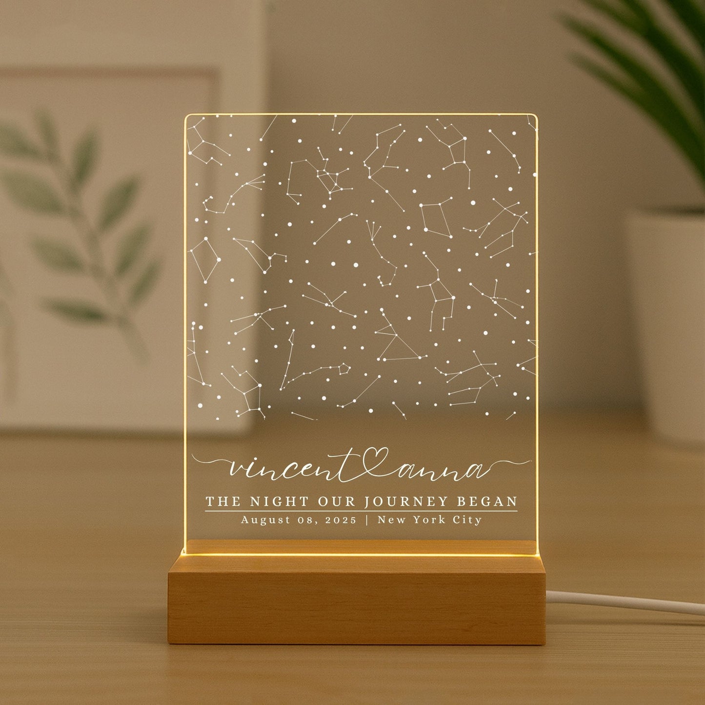 Warm ambient glow from a star map night light on a bedside table in a living room.